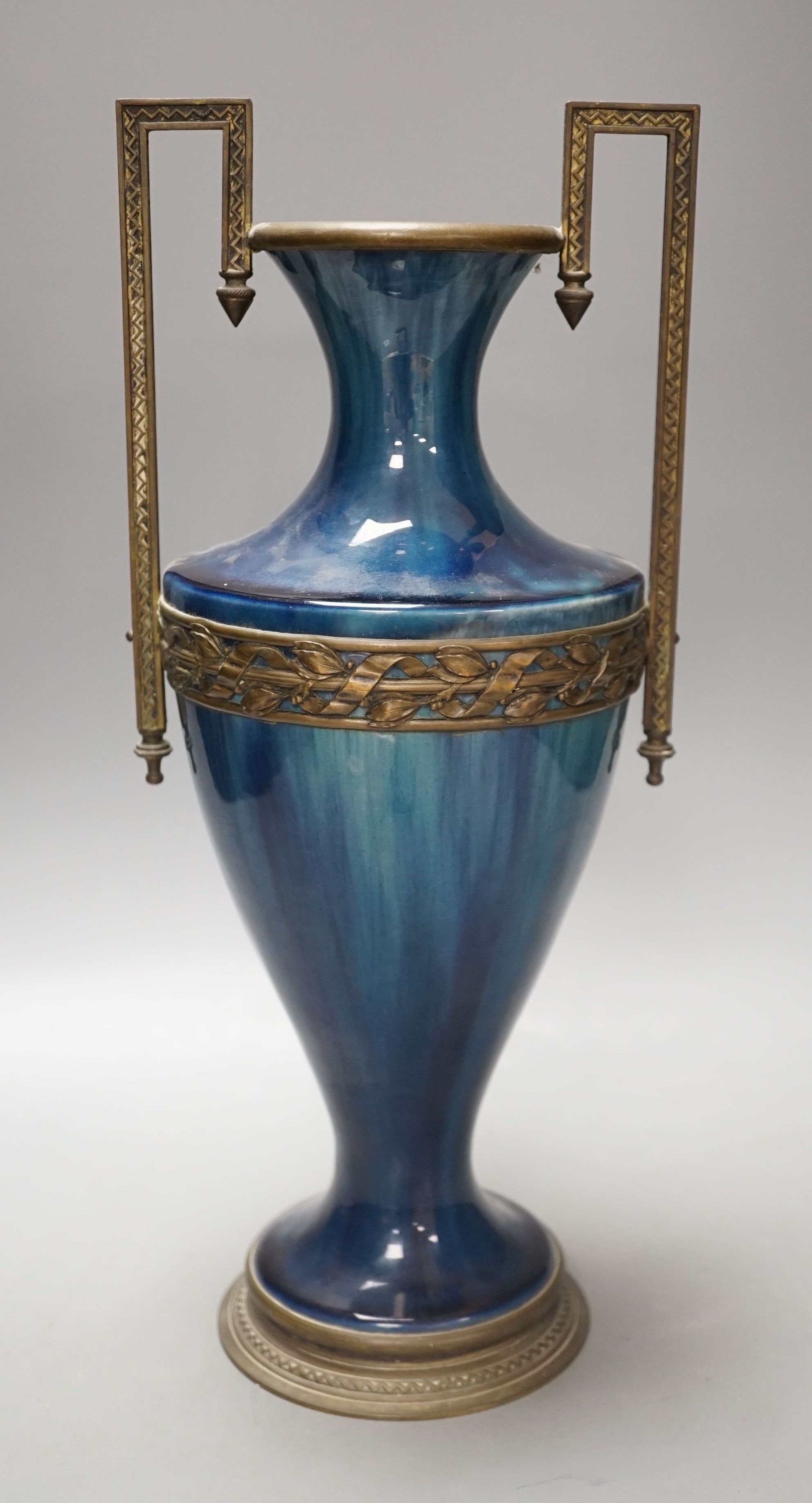 A French blue-glazed vase with embossed metal mounts, c.1900, 37 cms high.